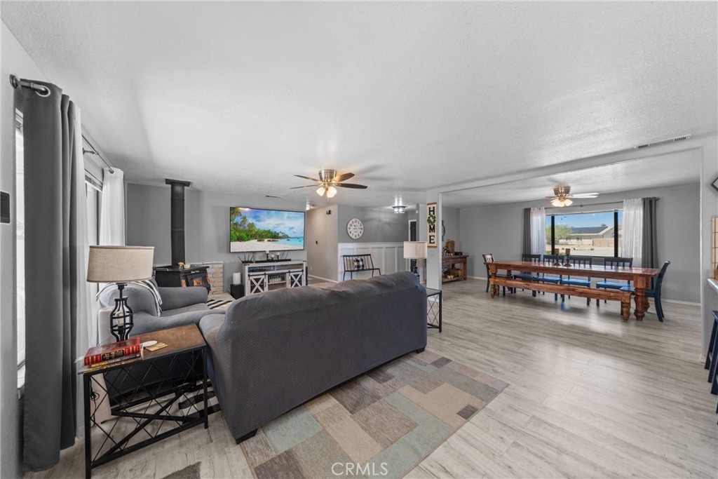 16161 St Timothy Road Apple Valley, CA 92307 - Photo 11 of 35 a living room with furniture and a dining table with kitchen view