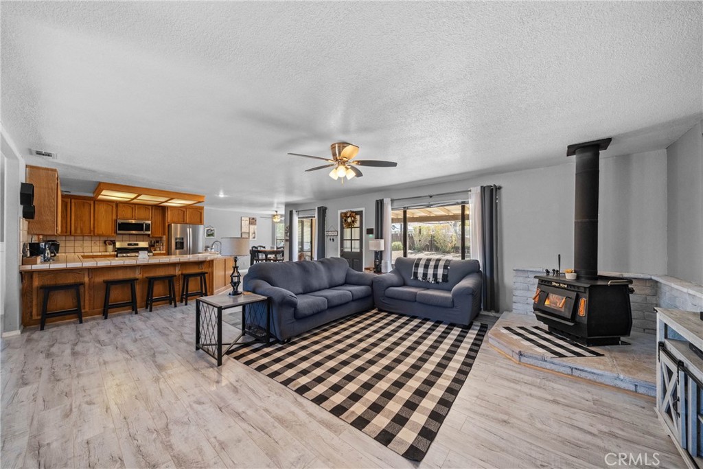 16161 St Timothy Road Apple Valley, CA 92307 - Photo 13 of 35 a living room with furniture and a kitchen view