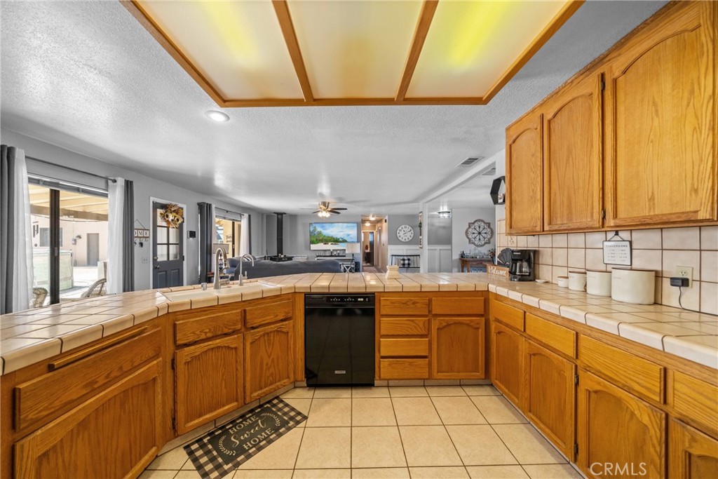 16161 St Timothy Road Apple Valley, CA 92307 - Photo 16 of 35 a kitchen with a sink and cabinets