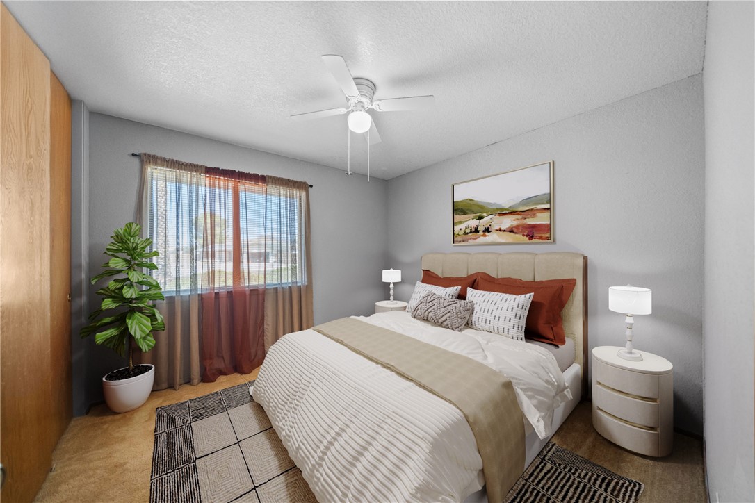 16161 St Timothy Road Apple Valley, CA 92307 - Photo 22 of 35 a bedroom with a bed and a potted plant
