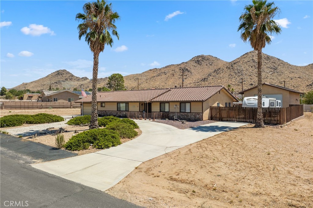 16161 St Timothy Road Apple Valley, CA 92307 - Photo 4 of 35 a front view of a house with a yard and garage