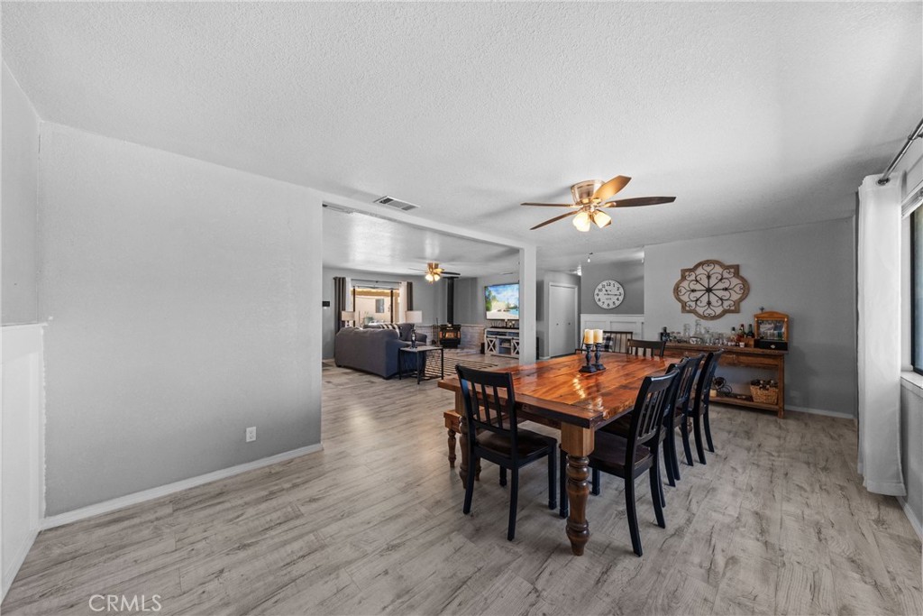 16161 St Timothy Road Apple Valley, CA 92307 - Photo 7 of 35 a view of a dining room with furniture and wooden floor