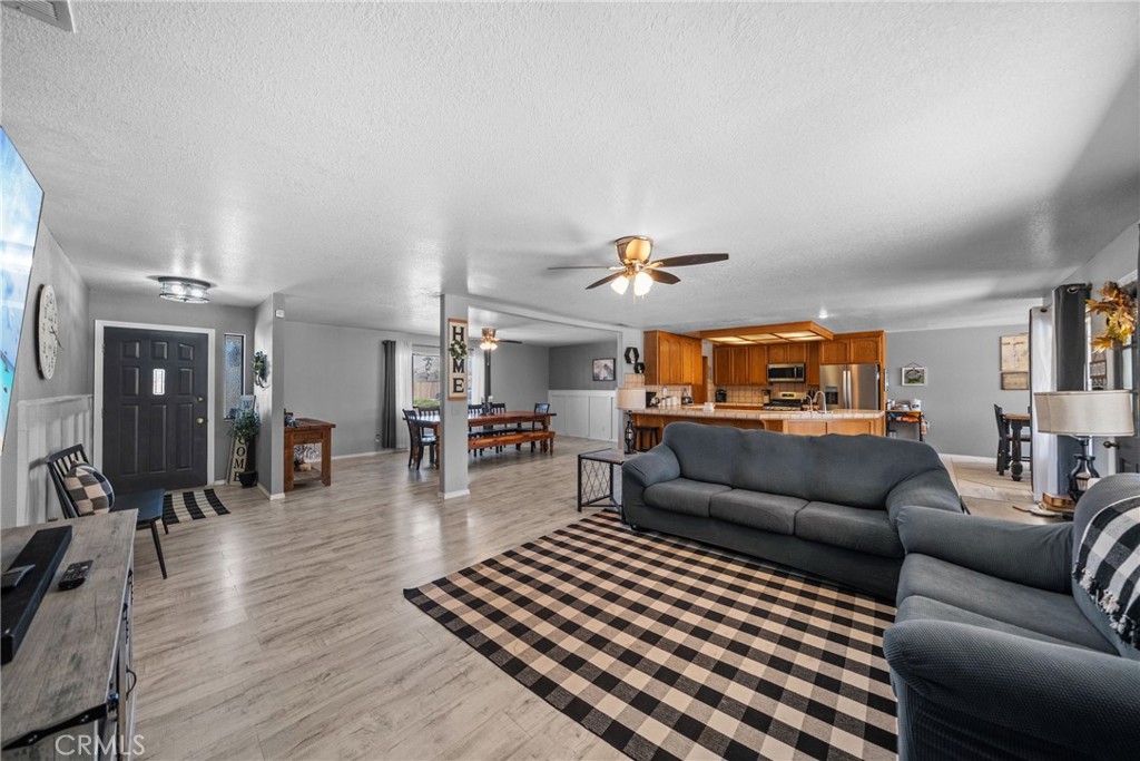 16161 St Timothy Road Apple Valley, CA 92307 - Photo 10 of 35 a living room with furniture and wooden floor