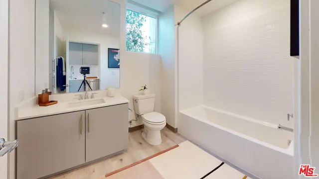 a bathroom with a sink toilet tub and shower