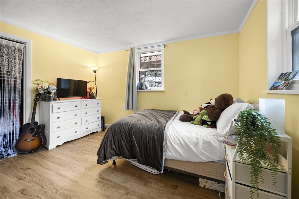 70 Jamaicaway, Unit 1 Boston, MA 02130 - Photo 11 of 19 a bedroom with a bed and a tv