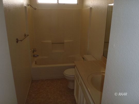 733 Commercial Ridgecrest, CA 93555 - Photo 4 of 15 a bathroom with a granite countertop toilet and a shower