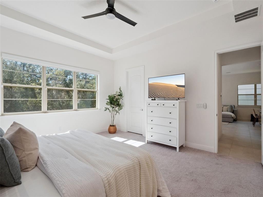2932 Tupelo Loop St. Cloud, FL 34772 - Photo 19 of 47 a spacious bedroom with a bed and a large window