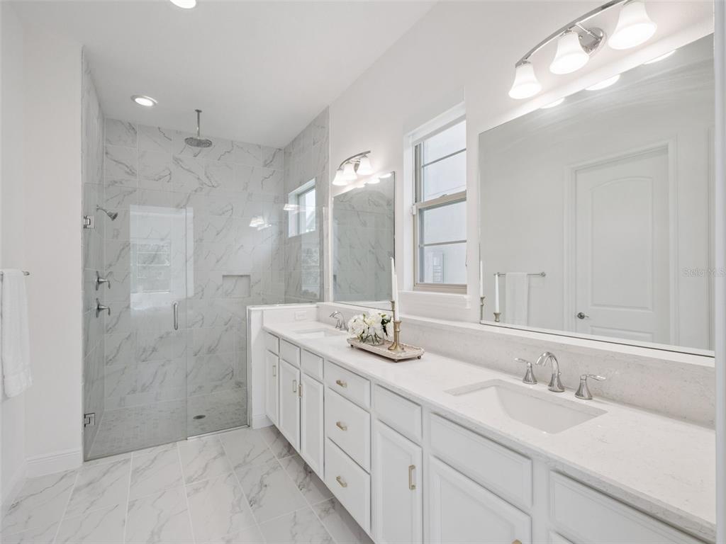 2932 Tupelo Loop St. Cloud, FL 34772 - Photo 21 of 47 a bathroom with double sink and a mirror