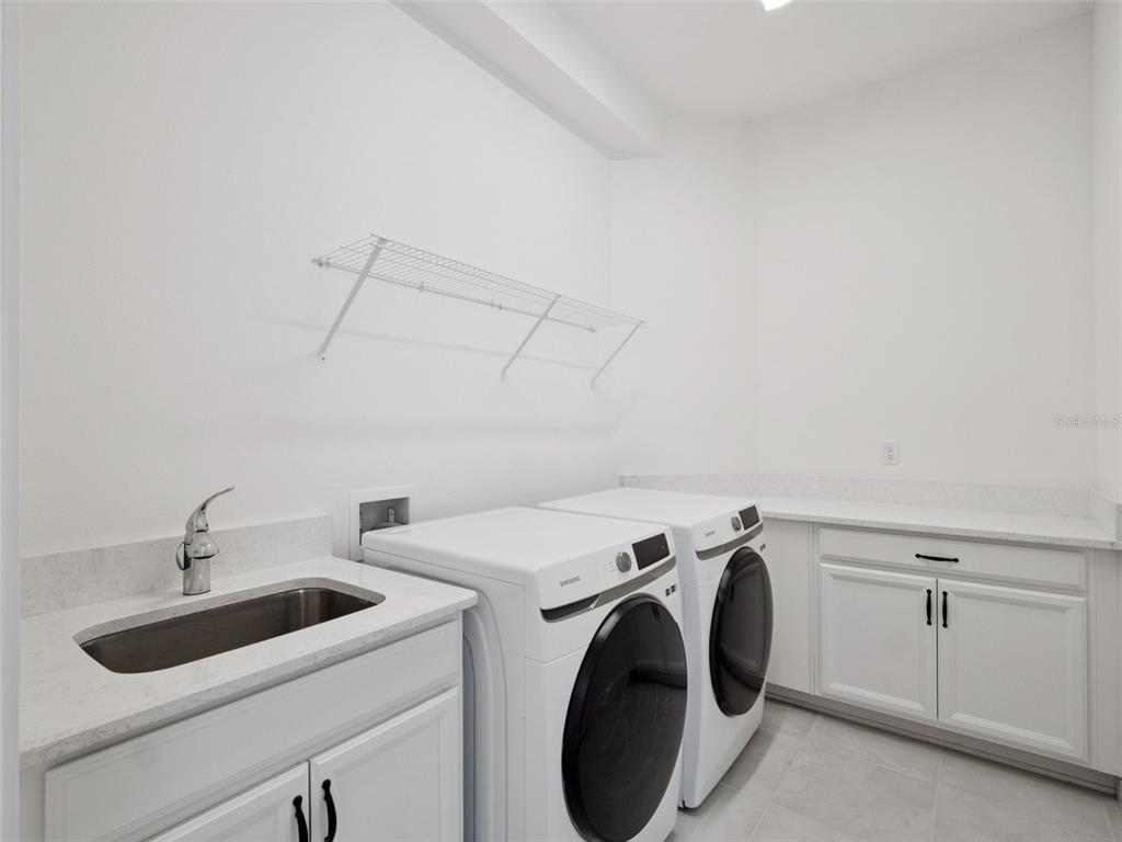 2932 Tupelo Loop St. Cloud, FL 34772 - Photo 23 of 47 a utility room with dryer and washer