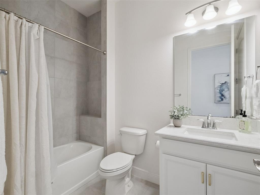 2932 Tupelo Loop St. Cloud, FL 34772 - Photo 4 of 47 a bathroom with a sink a toilet and shower