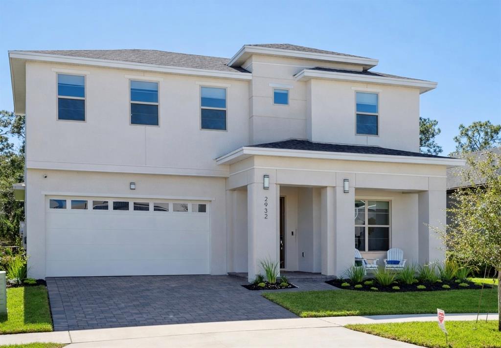 2932 Tupelo Loop St. Cloud, FL 34772 - Photo 47 of 47 a front view of a house with a yard and garage