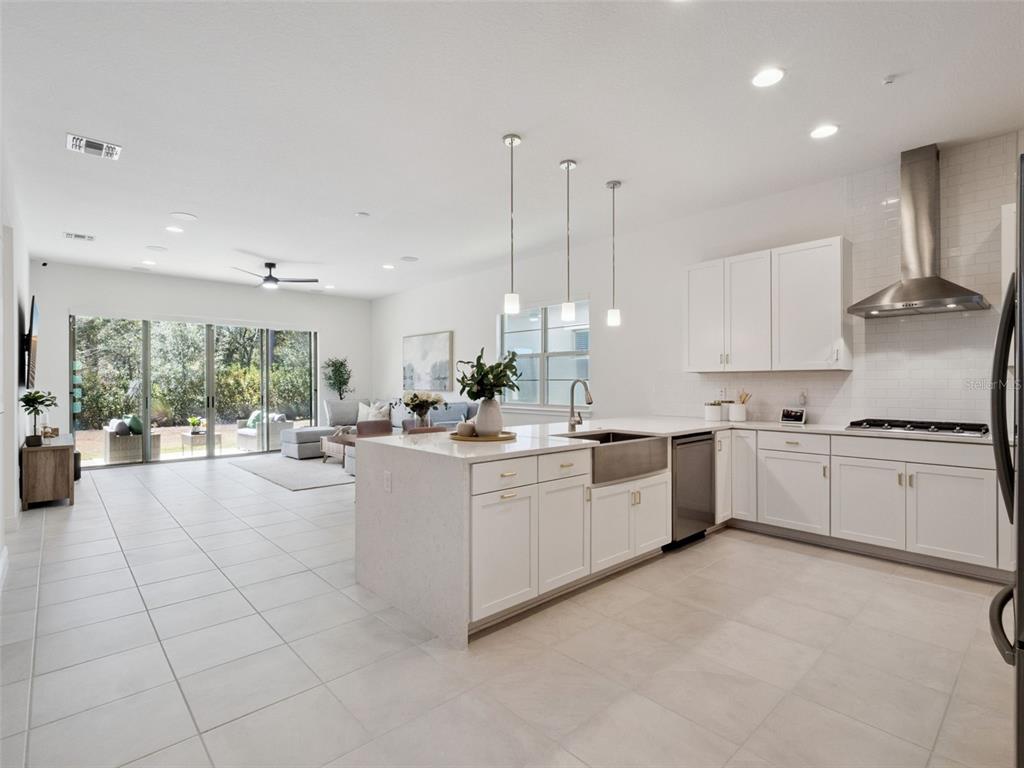 2932 Tupelo Loop St. Cloud, FL 34772 - Photo 6 of 47 a large white kitchen with cabinets a sink and appliances