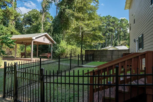 a view of a house with a small yard and furniture