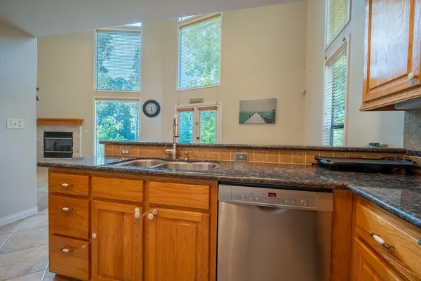 a kitchen with stainless steel appliances granite countertop a sink and a microwave