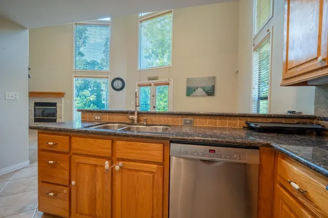 a kitchen with stainless steel appliances granite countertop a sink and a microwave