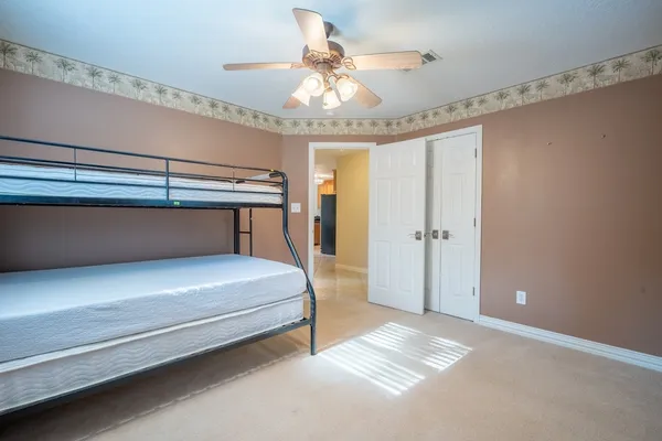 a bedroom with a bed and a chandelier