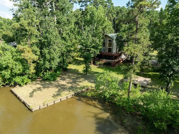 a backyard of a house with lots of green space and fountain