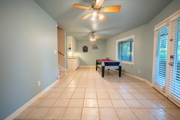 a view of a kitchen with kitchen island a sink a stove and a chandelier