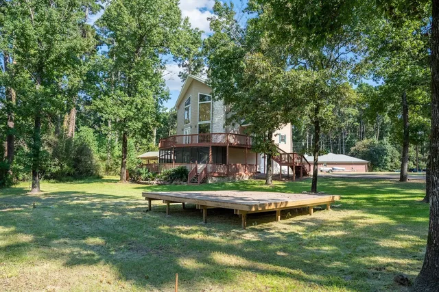a view of a house with a yard patio and swimming pool