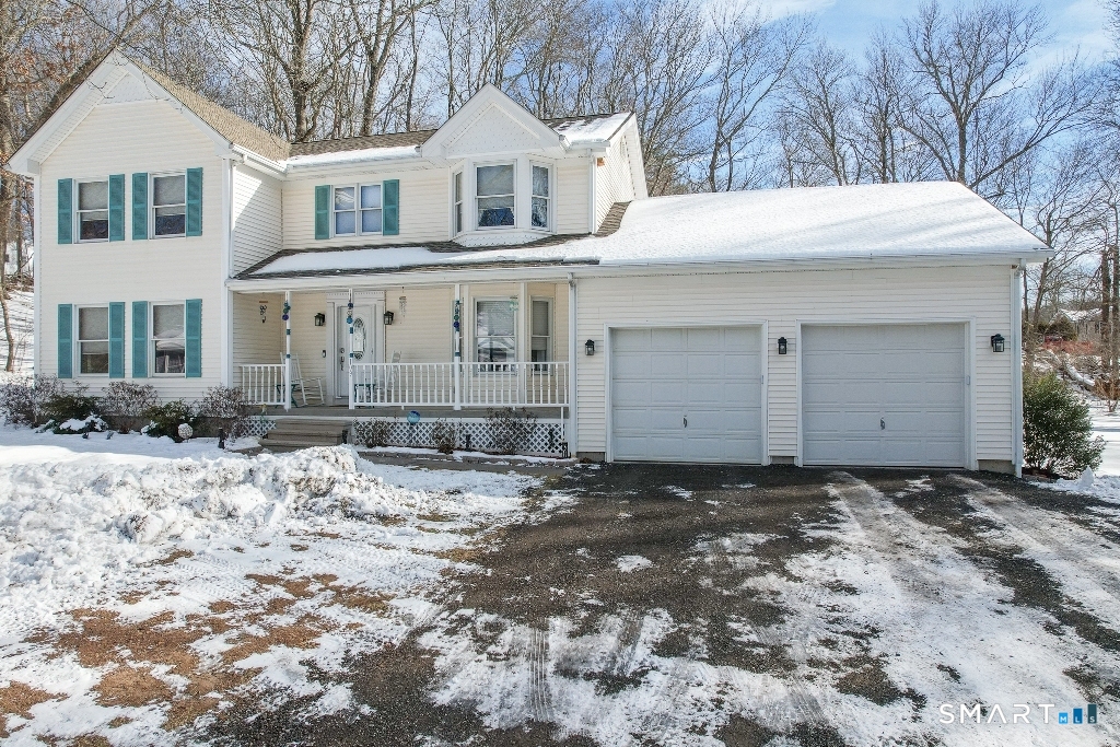 a view of a white house with a yard