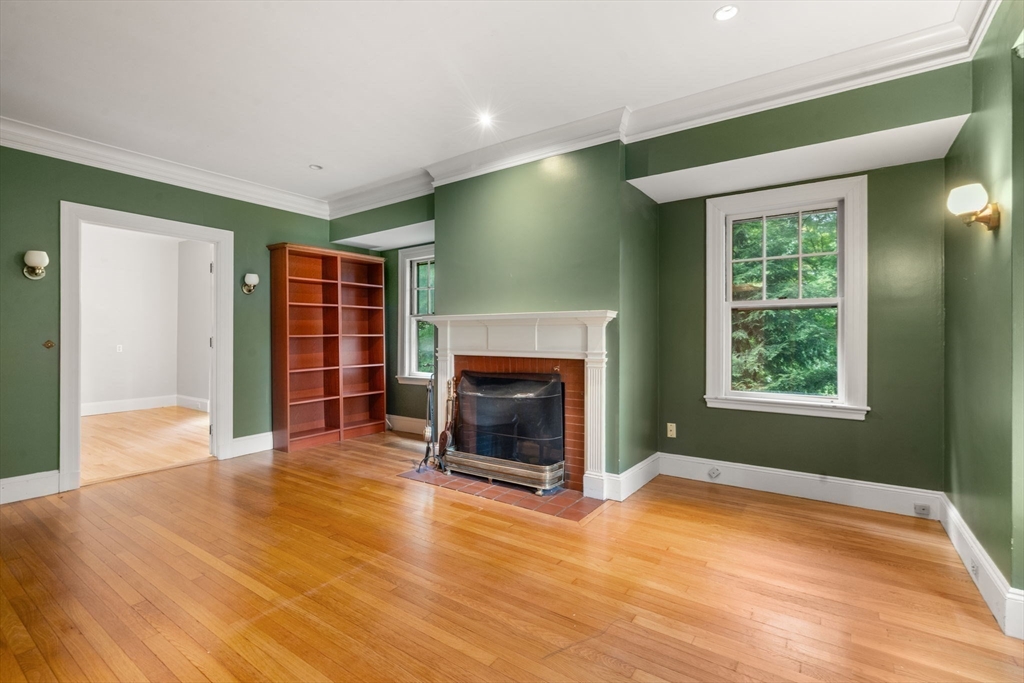17 Longfellow Road Wellesley, MA 02481 - Photo 3 of 20 a view of an empty room with wooden floor fireplace and a window