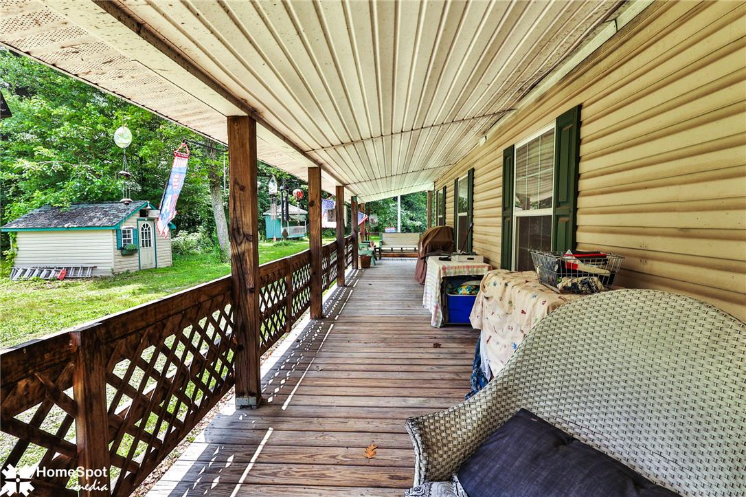 3795 Rhoades Road Kempton, PA 19529 - Photo 40 of 42 A spacious covered porch extends across this charming residence, offering tranquil outdoor living with views of the natural landscape.
