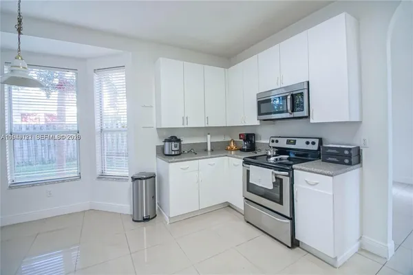 a kitchen with a refrigerator a stove top oven a sink and dishwasher