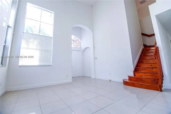 an entryway in an empty room with a window