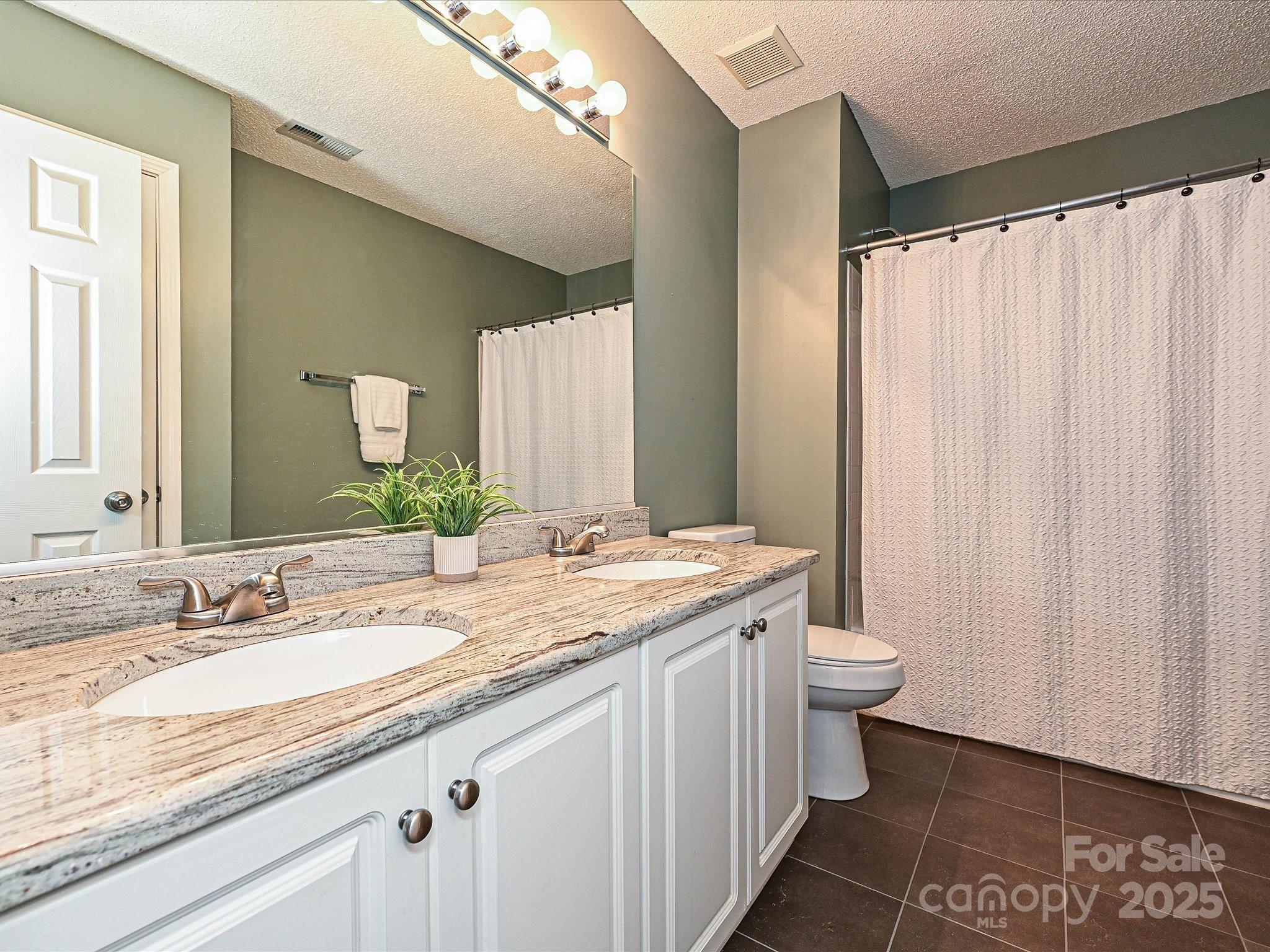 557 South Portman Lane Fort Mill, SC 29708 - Photo 21 of 29 a bathroom with a granite countertop sink and a mirror