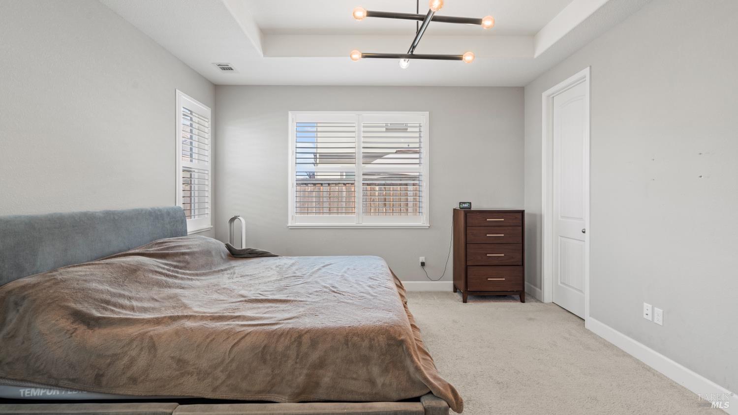 761 Razorbill Street Vacaville, CA 95688 - Photo 14 of 41 a bedroom with a bed and dresser with chair