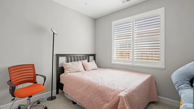 a bedroom with a bed and chair