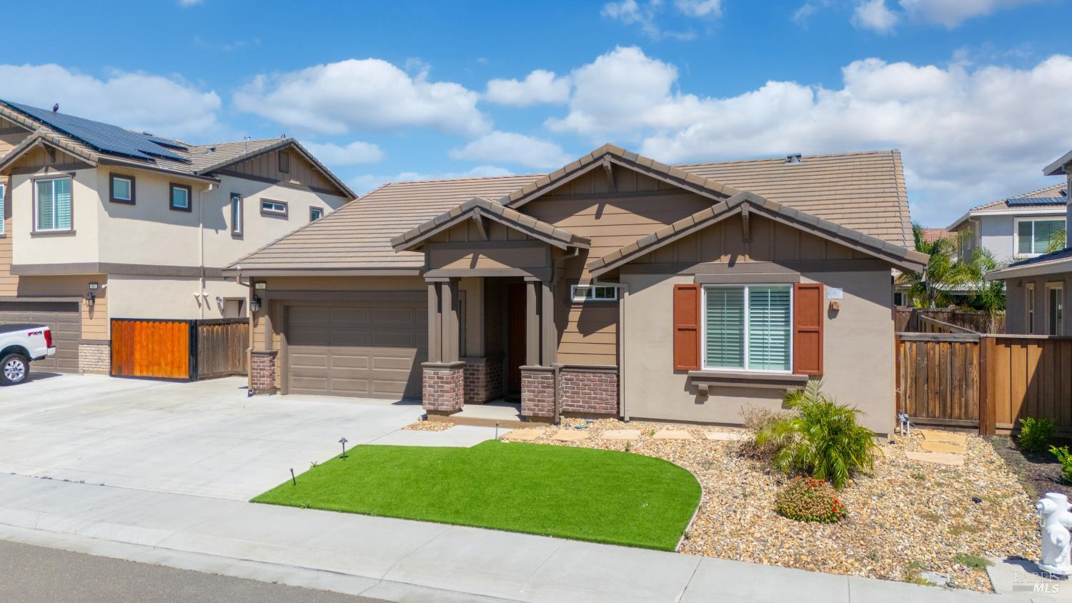 761 Razorbill Street Vacaville, CA 95688 - Photo 28 of 41 a view of a white house with large windows and a yard