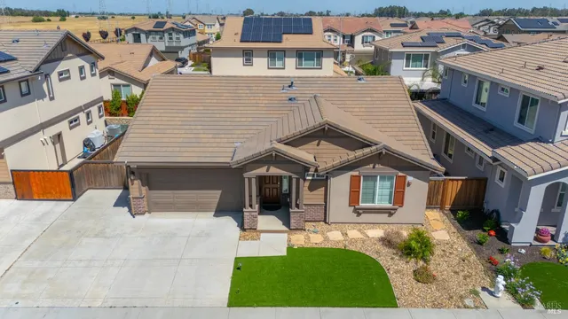 an aerial view of a house with a yard