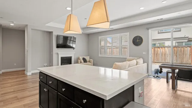 a living room with furniture a fireplace and a table