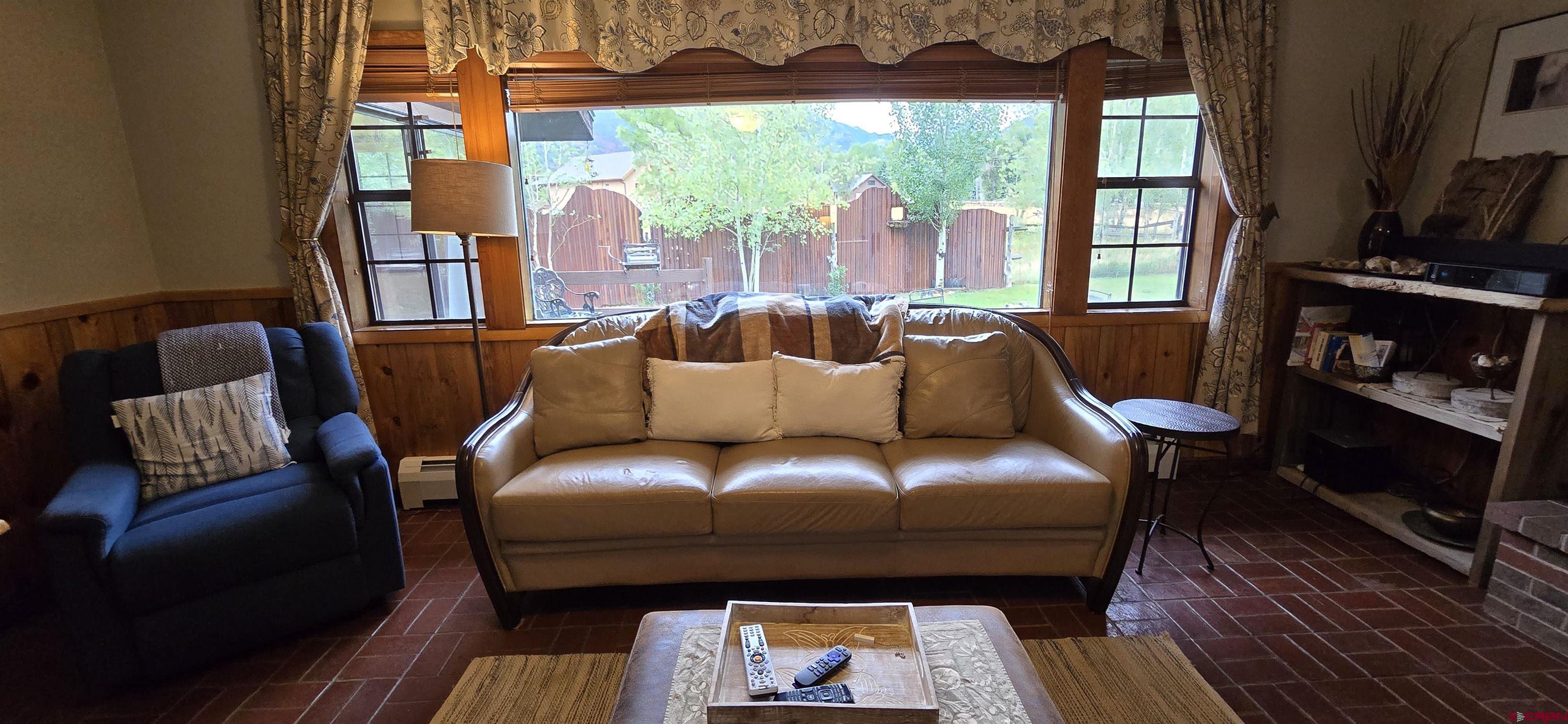 605 County Road 23 Ridgway, CO 81432 - Photo 11 of 26 a living room with furniture and a fireplace