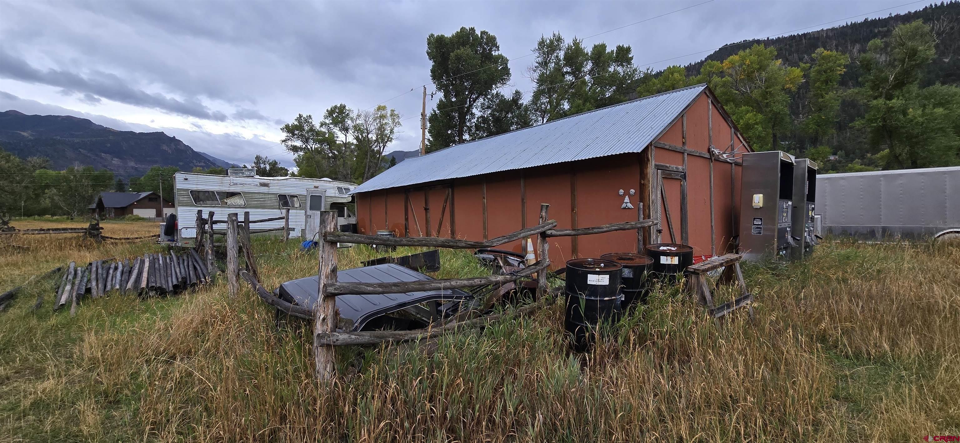 605 County Road 23 Ridgway, CO 81432 - Photo 23 of 26 a backyard of a house with barbeque oven table and chairs
