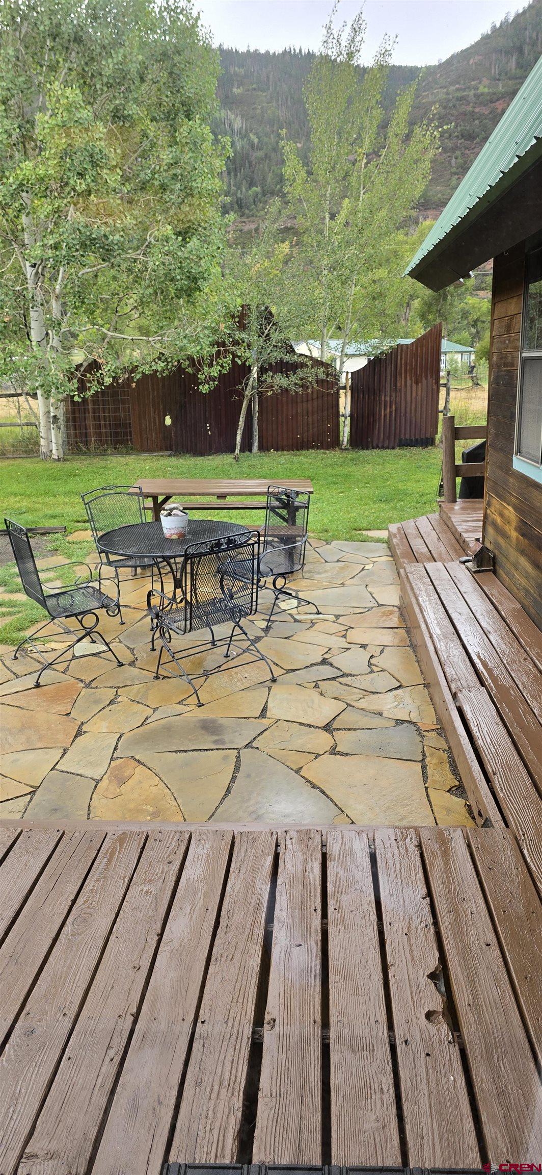 605 County Road 23 Ridgway, CO 81432 - Photo 3 of 26 a view of a patio with lawn chairs next to a yard