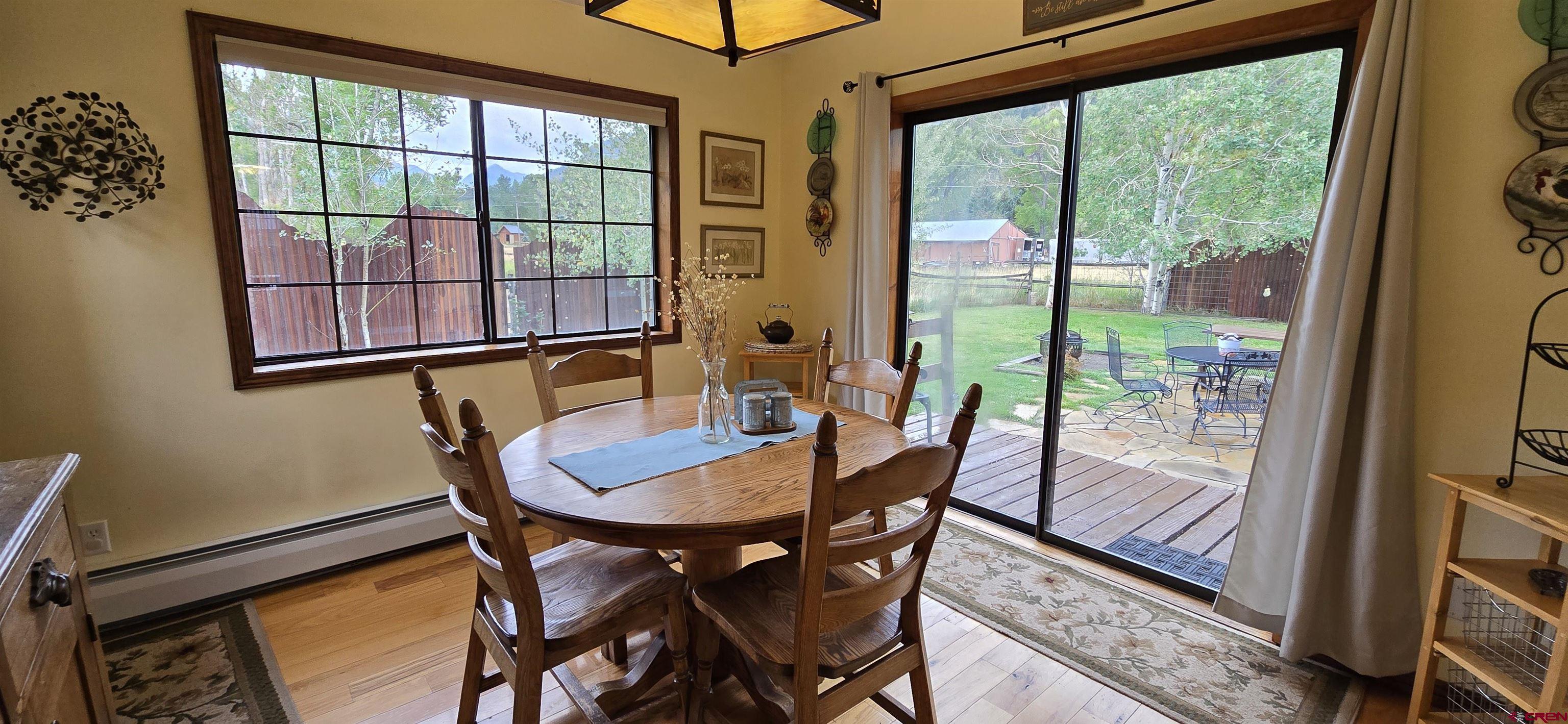 605 County Road 23 Ridgway, CO 81432 - Photo 5 of 26 a dining room with furniture a rug and wooden floor