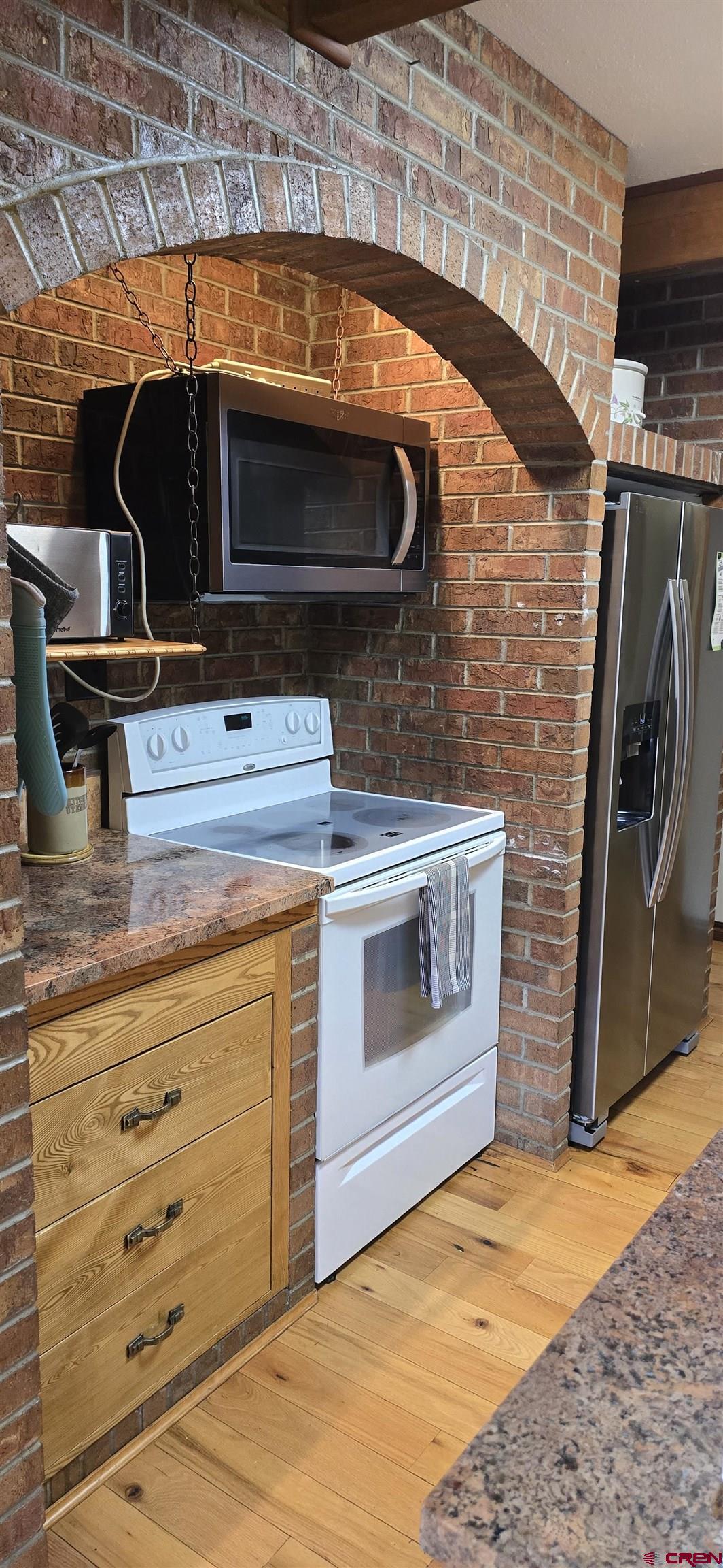 605 County Road 23 Ridgway, CO 81432 - Photo 6 of 26 a kitchen with a stove and a microwave