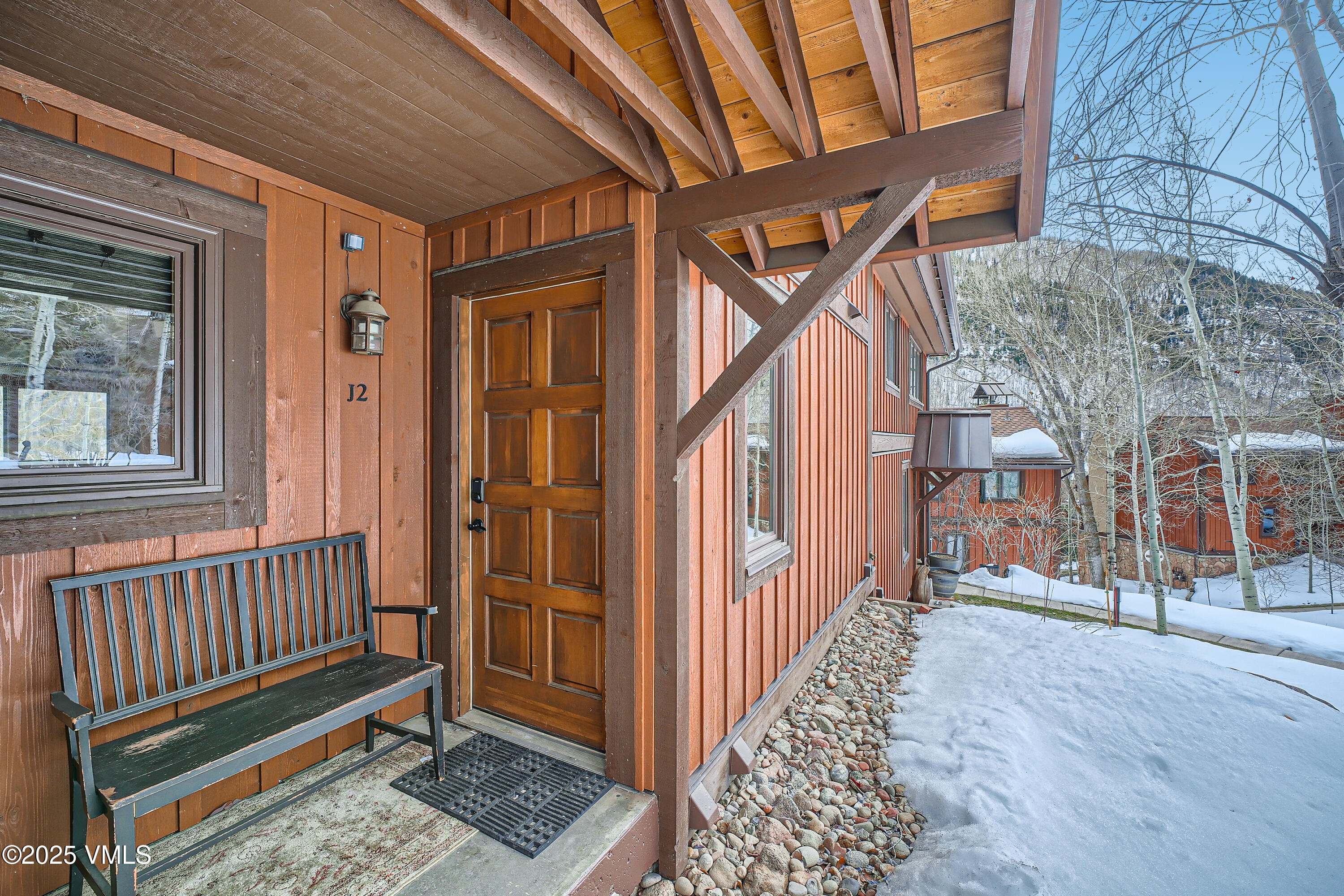 2875 Manns Ranch Road, Unit J2 Vail, CO 81657 - Photo 25 of 25 a view of a house with a bench