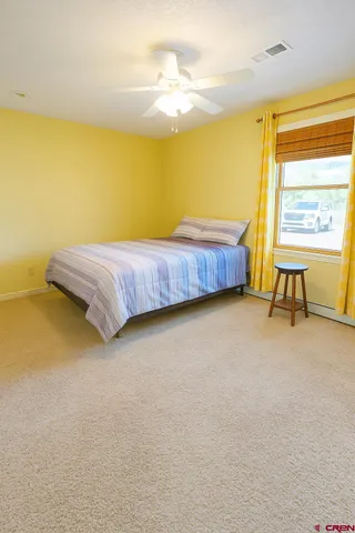 a bedroom with a bed and a table in it