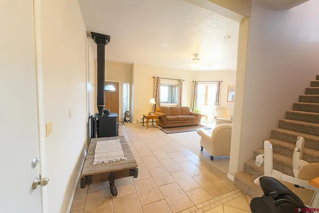 a living room with furniture a rug and white walls