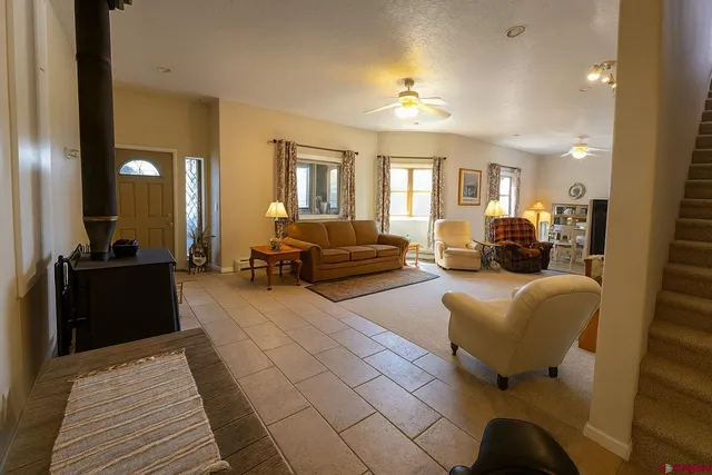 a living room with furniture and a chandelier