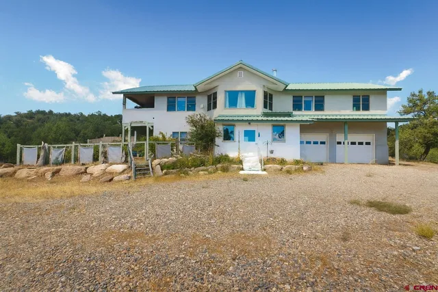a view of a house with a yard and sitting area