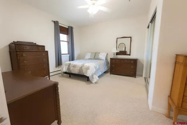 a bedroom with a bed and a mirror