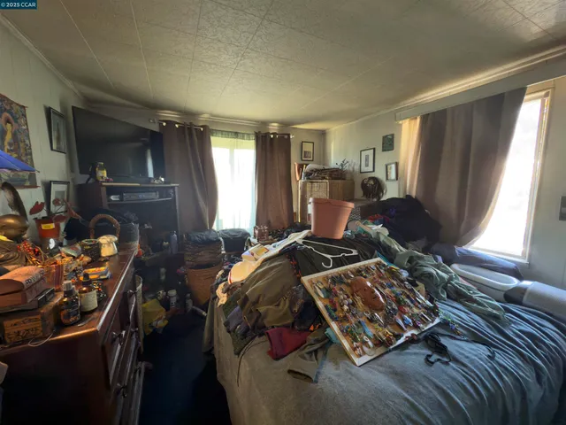 a bed sitting in a bedroom next to a window