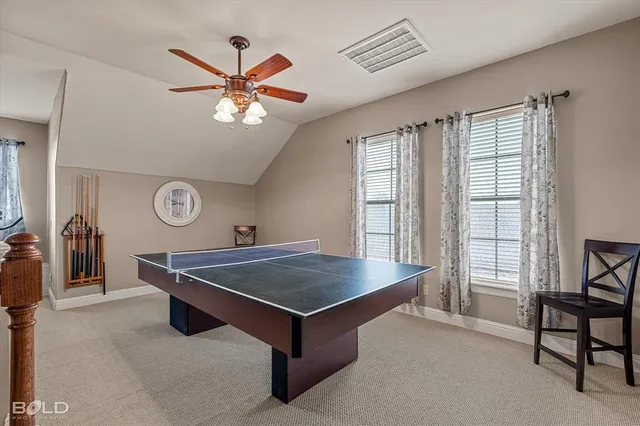 a living room with pool table and a window