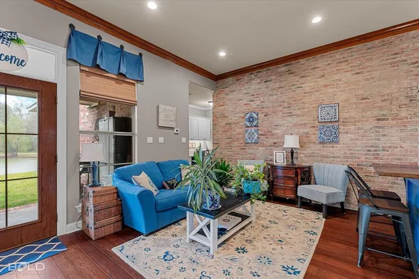 a living room with furniture wooden floor and a large window