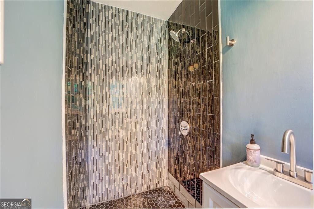 1288 Elva Drive Southwest Atlanta, GA 30331 - Photo 11 of 13 a bathroom with a shower curtain and a sink