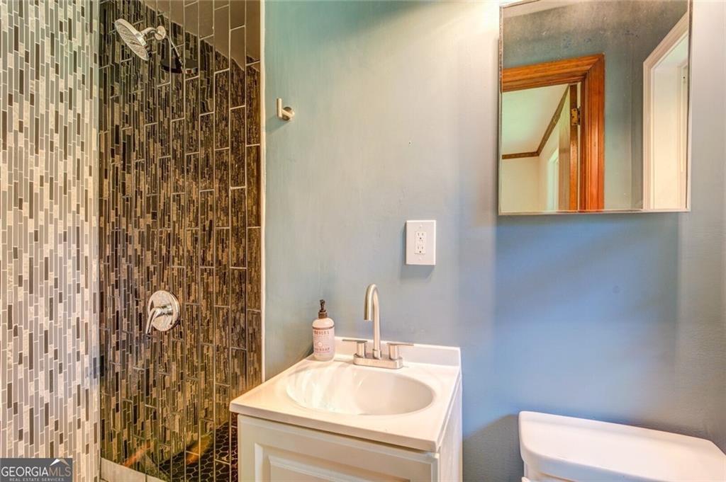 1288 Elva Drive Southwest Atlanta, GA 30331 - Photo 13 of 13 a bathroom with a sink a toilet and shower curtain